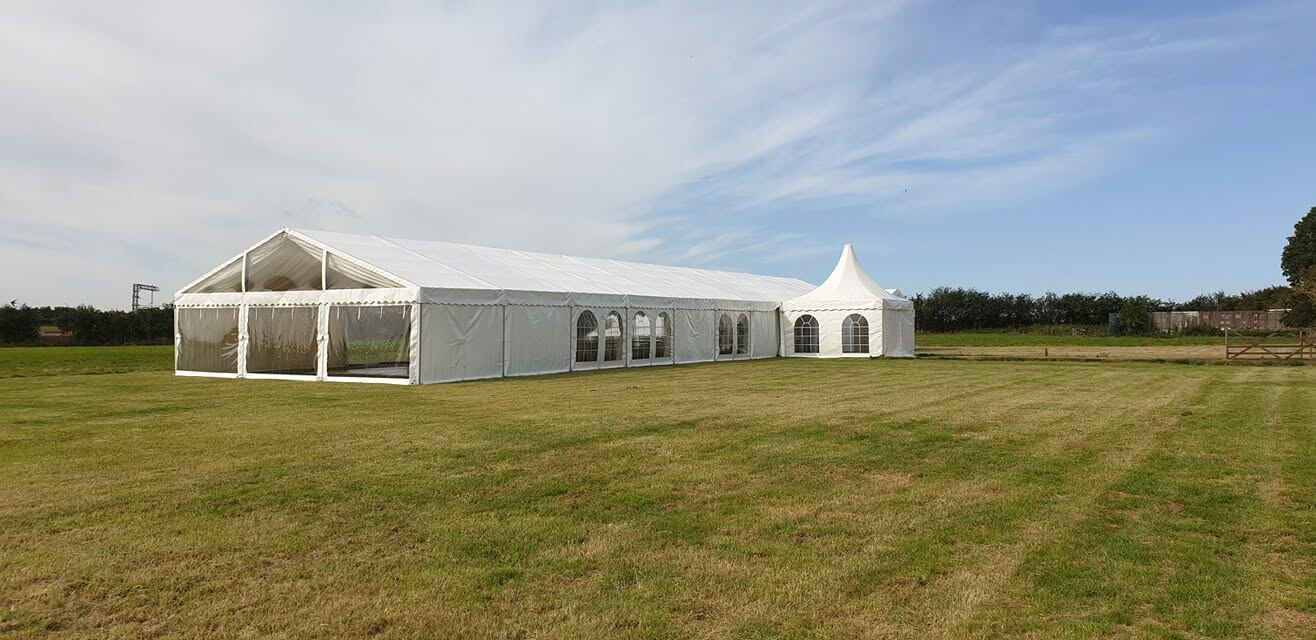 Marquee hire in open field for outdoor event