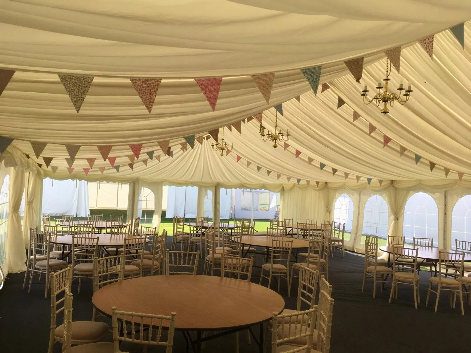 Marquee tables with bunting and chandeliers