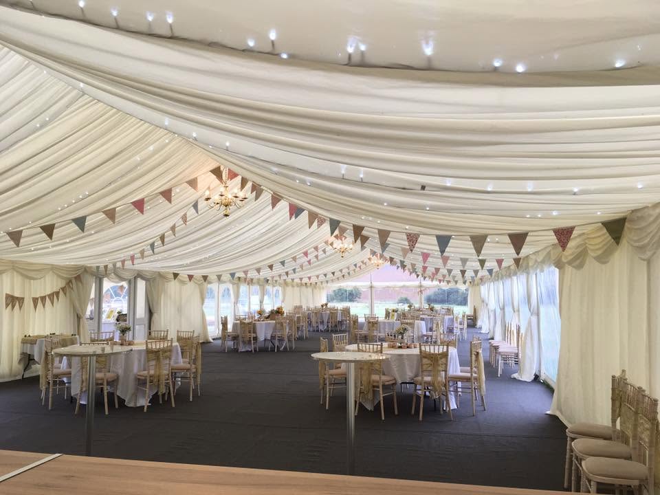 Marquee interior with warm lighting and flooring, Northamptonshire